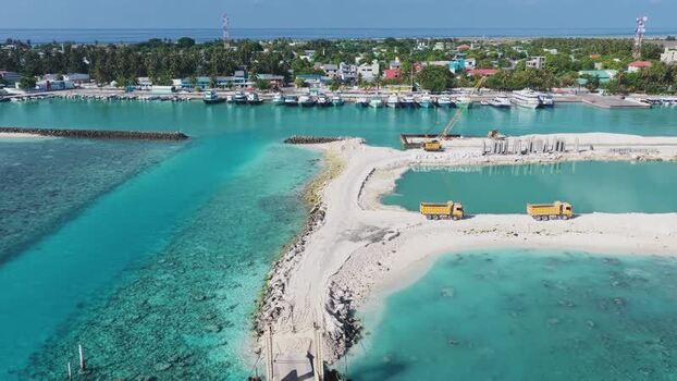 Aerial view of harbor construction with trucks and boats Maldives. Aerial view of harbor construction with trucks and boats Maldives.