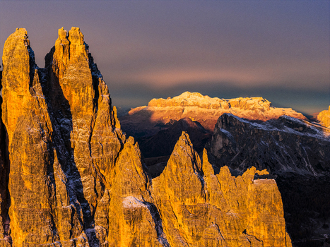 Aerial view of jagged peak Croda da Lago with the warm hues of the Enrosadira in the background Sellaa Pordoi range Dolomites Italy.