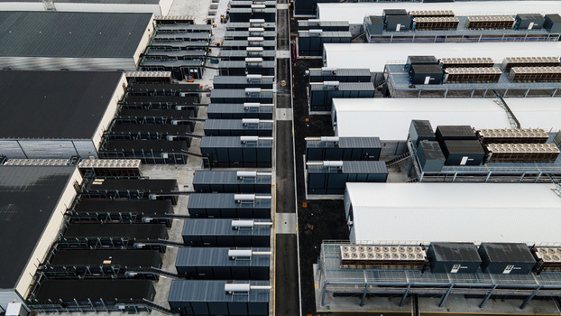 Aerial view of a large data center facility featuring rows of server containers and industrial cooling systems in Keflavik Reykjanesbaer Iceland. Aerial view of a large data center facility featuring rows of server containers and industrial cooling systems in Keflavik Reykjanesbaer Iceland.