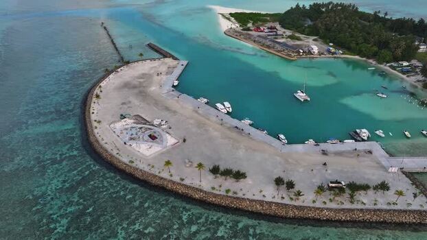 Aerial view of a tropical harbor with boats in turquoise water Maldives. Aerial view of a tropical harbor with boats in turquoise water Maldives.