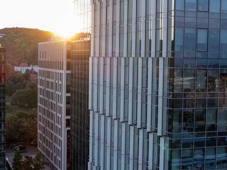Aerial view of modern glass office buildings reflecting the warm sunset light in the urban landscape of Gdansk Poland. Aerial view of modern glass office buildings reflecting the warm sunset light in the urban landscape of Gdansk Poland.