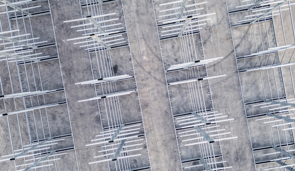 Aerial view of a multi level vehicle storage structure with metal framing and concrete ground in Livron sur Drome Auvergne Rhone Alpes France. Aerial view of a multi level vehicle storage structure with metal framing and concrete ground in Livron sur Drome Auvergne Rhone Alpes France.