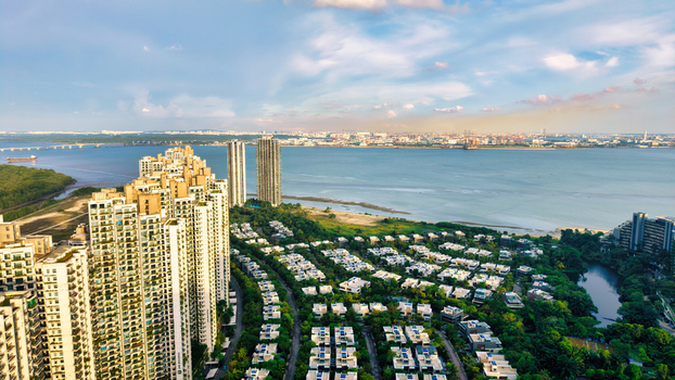 Aerial view of Forest City featuring modern high rise residential towers lush green landscaping and coastal villas overlooking the sea in Gelang Patah Johor Darul Ta zim Malaysia.