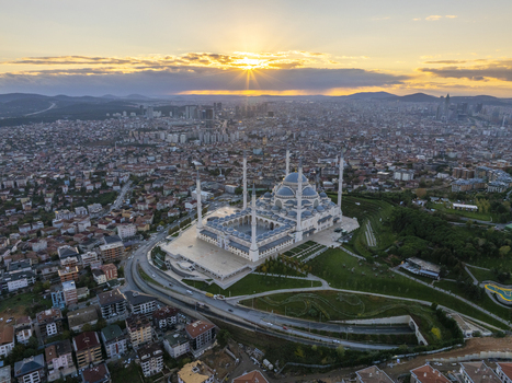 Aerial view of Grand Camlica Mosque surrounded by urban landscape and lush greenery at sunset in Uskudar Istanbul Turkiye. Aerial view of Grand Camlica Mosque surrounded by urban landscape and lush greenery at sunset in Uskudar Istanbul Turkiye.