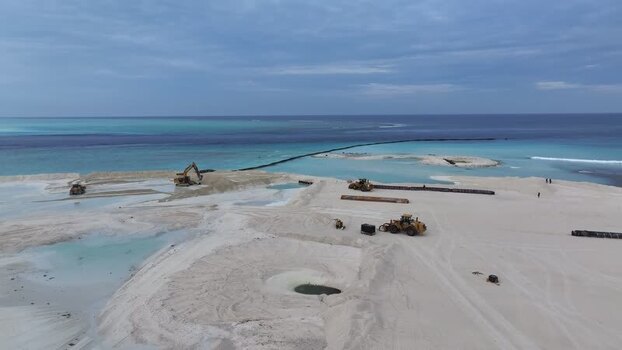 Aerial view of heavy machinery on a beach in Gulhi Maldives.