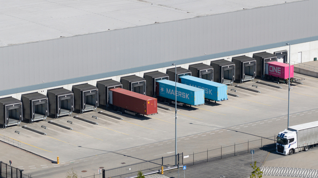 Rotterdam Netherlands 01 May 2026 Aerial view of logistics warehouse loading docks with colorful shipping containers from Maersk and ONE in an industrial zone. Rotterdam Netherlands 01 May 2026 Aerial view of logistics warehouse loading docks with colorful shipping containers from Maersk and ONE in an industrial zone.