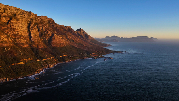 Aerial view of the rugged Twelve Apostles mountain range and the Atlantic coastline during golden hour Cape Town Western Cape South Africa. Aerial view of the rugged Twelve Apostles mountain range and the Atlantic coastline during golden hour Cape Town Western Cape South Africa.