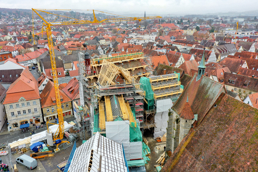 Aerial view of Rathaus Forchheim under renovation with a yellow crane and scaffolding amidst historic red tiled rooftops Forchheim Bayern Germany. Aerial view of Rathaus Forchheim under renovation with a yellow crane and scaffolding amidst historic red tiled rooftops Forchheim Bayern Germany.