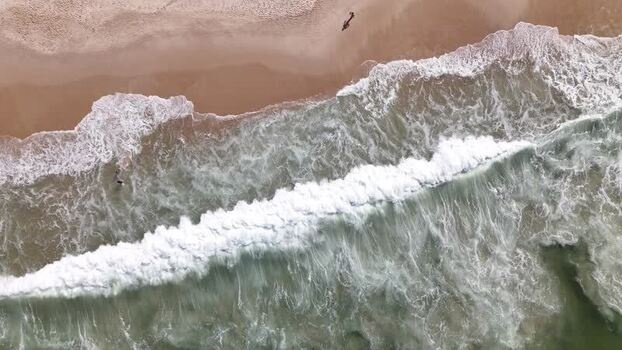Aerial view of waves crashing on Copacabana Beach Brazil.