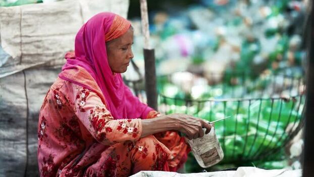 View of a woman sorting plastic bottles in Bogura Bangladesh. View of a woman sorting plastic bottles in Bogura Bangladesh.