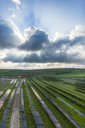 Aerial view of FVE Bohumilice solar power plant with rows of photovoltaic panels under a dramatic cloudy sky with sunbeams in Klobouky u Brna Jihomoravsky kraj Czechia. Aerial view of FVE Bohumilice solar power plant with rows of photovoltaic panels under a dramatic cloudy sky with sunbeams in Klobouky u Brna Jihomoravsky kraj Czechia.