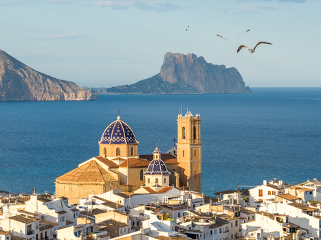 Aerial view of the iconic blue domed Church of the Virgin of the Consolation overlooking the white rooftops of the old town and the Mediterranean Sea in Altea Valencian Community Spain.