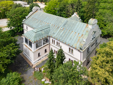 Aerial view of Tihanyi Mansion with its distinctive green copper roof surrounded by lush trees and greenery in Banska Bystrica Banskobystricky kraj Slovakia. Aerial view of Tihanyi Mansion with its distinctive green copper roof surrounded by lush trees and greenery in Banska Bystrica Banskobystricky kraj Slovakia.