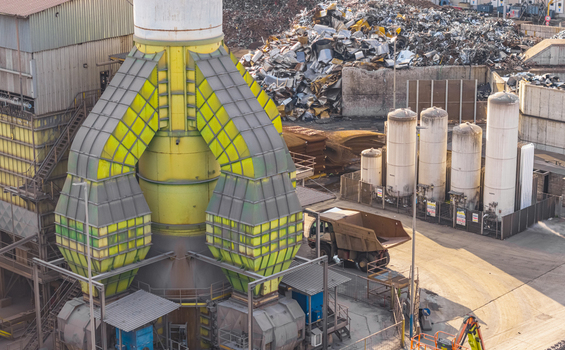 Aerial view of the industrial air filtration and exhaust system at the Alfa Acciai steel plant with scrap metal storage and storage tanks in Brescia Lombardy Italy.