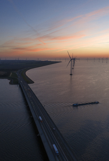 Aerial view of the Ketelbrug bridge with traffic and wind turbines in Nagele Flevoland Netherlands.