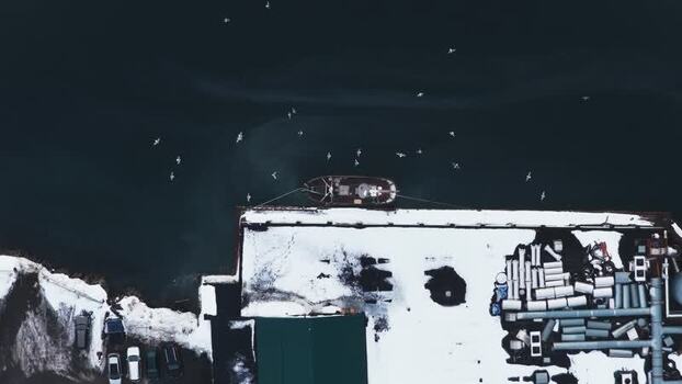 Aerial view of boat near snowy dock Norway.