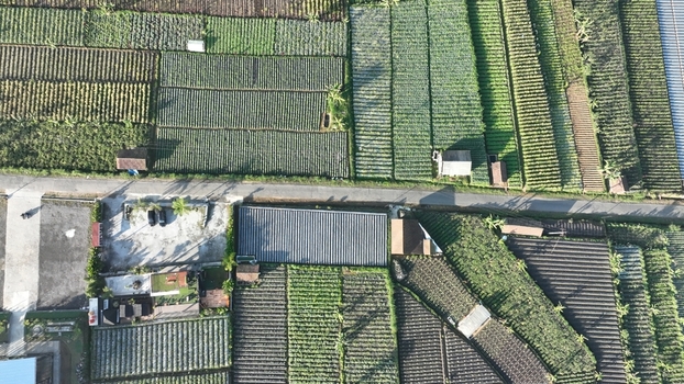 Aerial view of Senja Pagi Cafe And Glamping surrounded by lush terraced agricultural fields and vegetable plots in Kecamatan Ngablak Jawa Tengah Indonesia. Aerial view of Senja Pagi Cafe And Glamping surrounded by lush terraced agricultural fields and vegetable plots in Kecamatan Ngablak Jawa Tengah Indonesia.