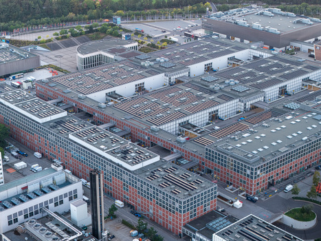Aerial view of Messe Berlin exhibition grounds featuring large industrial buildings with brick facades and flat roofs in Berlin Berlin Germany. Aerial view of Messe Berlin exhibition grounds featuring large industrial buildings with brick facades and flat roofs in Berlin Berlin Germany.