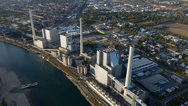 Aerial view of the Grosskraftwerk Mannheim power plant along the Rhine river with tall chimneys and industrial infrastructure in Mannheim Baden Wurttemberg Germany.