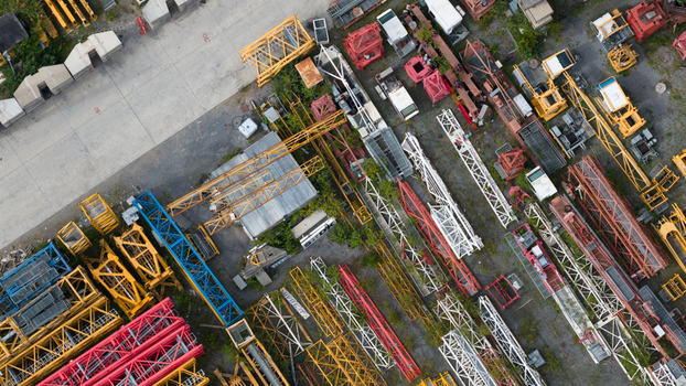 Aerial view of the Feluy de Parc Industriel featuring a collection of colorful construction cranes and industrial equipment stored in an open yard in Seneffe Region wallonne Belgium.