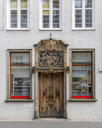 Gdansk Pomeranian Voivodeship Poland 07 September 2026 View of an ornate wooden door with intricate carvings and a decorative stone lintel on a historic building facade. Gdansk Pomeranian Voivodeship Poland 07 September 2026 View of an ornate wooden door with intricate carvings and a decorative stone lintel on a historic building facade.