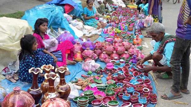 View of people selling colorful pottery at a street market Bangladesh. View of people selling colorful pottery at a street market Bangladesh.