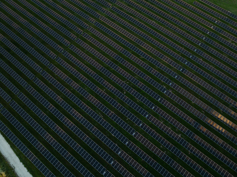 Aerial view of a large solar panel farm with rows of photovoltaic modules on green grass in Augusta Sicily Italy. Aerial view of a large solar panel farm with rows of photovoltaic modules on green grass in Augusta Sicily Italy.