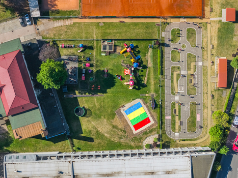 Aerial view of a colorful children s playground and a miniature traffic park with road markings and green lawns in Kyjov South Moravian Region Czechia.