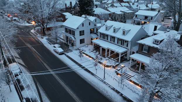 Aerial view of historic houses covered in fresh snow along a quiet street at dawn in Lititz Pennsylvania United States. Aerial view of historic houses covered in fresh snow along a quiet street at dawn in Lititz Pennsylvania United States.