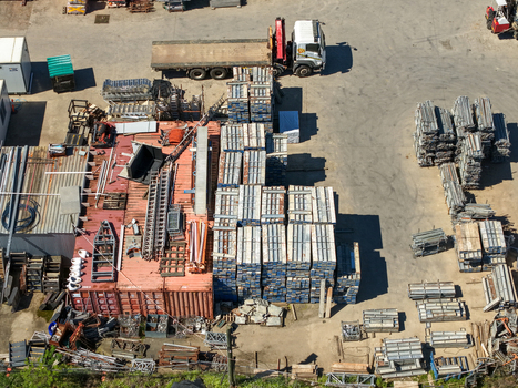 Kilsyth Victoria Australia 20 September 2026 Aerial view of industrial yard with stacked scaffolding metal components and a transport truck. Kilsyth Victoria Australia 20 September 2026 Aerial view of industrial yard with stacked scaffolding metal components and a transport truck.