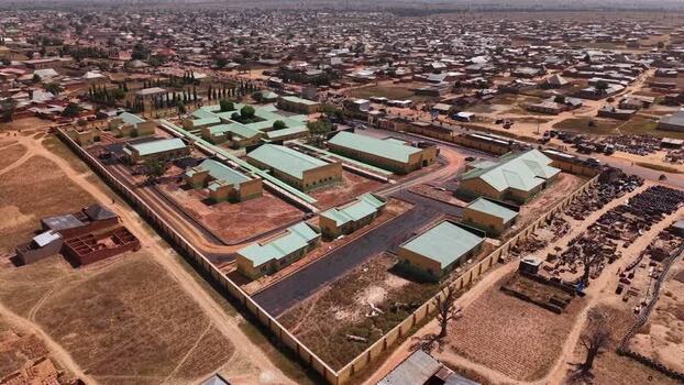 Aerial view of a walled facility with green roofs in Nigeria.
