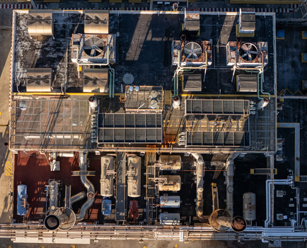Aerial view of the beer industrial complex featuring large cooling units intricate piping systems and storage tanks on the rooftop in Santo Domingo Dominican Republic. Aerial view of the beer industrial complex featuring large cooling units intricate piping systems and storage tanks on the rooftop in Santo Domingo Dominican Republic.