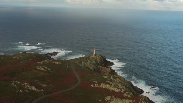 Aerial view of Faro de Punta Nariga lighthouse on the coast Spain.