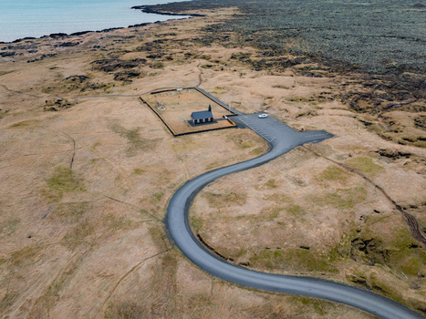 Aerial view of the iconic black church of Budir surrounded by vast volcanic fields and coastal landscape in Budir Snaefellsba Iceland. Aerial view of the iconic black church of Budir surrounded by vast volcanic fields and coastal landscape in Budir Snaefellsba Iceland.
