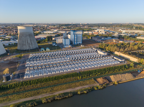 Aerial view of the Cargovil battery energy storage system with rows of battery containers cooling towers and industrial buildings situated along a canal in Vilvoorde Vlaanderen Belgium. Aerial view of the Cargovil battery energy storage system with rows of battery containers cooling towers and industrial buildings situated along a canal in Vilvoorde Vlaanderen Belgium.