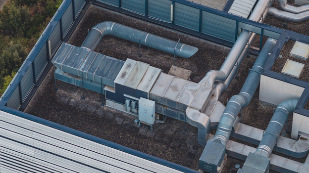 Aerial view of industrial rooftop ventilation equipment with large air ducts mechanical ventilation systems and HVAC infrastructure on a building in Alixan Auvergne Rhone Alpes France.