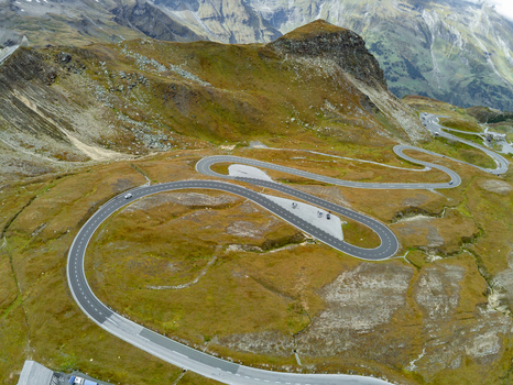 Aerial view of the Grossglockner High Alpine Road with its winding mountain curves asphalt road alpine meadows and rocky terrain in Zell am See District Salzburg Austria.