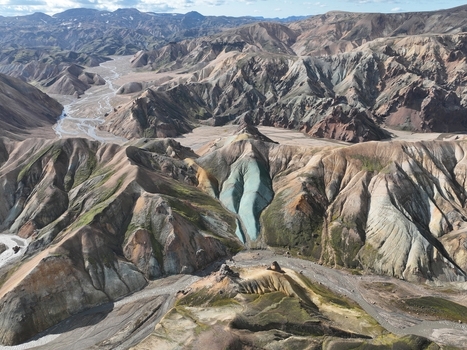 Aerial view of Landmannalaugar featuring colorful rhyolite mountains volcanic landscape braided rivers and dramatic geological formations in Hella Rangarthing ytra Iceland. Aerial view of Landmannalaugar featuring colorful rhyolite mountains volcanic landscape braided rivers and dramatic geological formations in Hella Rangarthing ytra Iceland.
