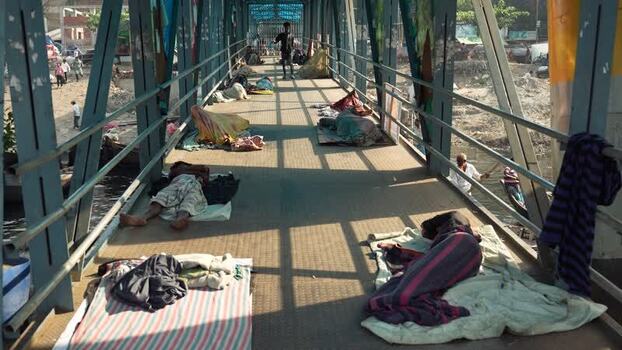 View of people sleeping on Sadarghat pedestrian bridge Bangladesh.