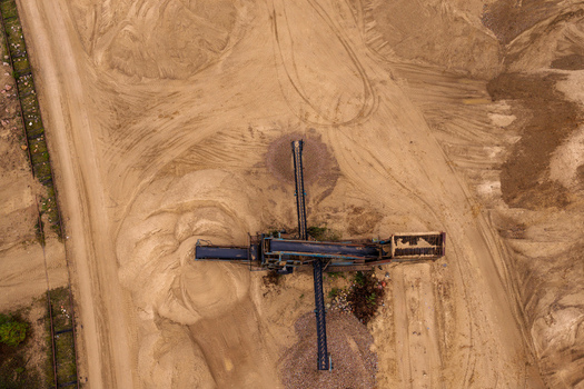 Aerial view of industrial machinery and conveyor belts operating in a sand quarry with large piles of earth and tire tracks Nemencine Vilnius County Lithuania. Aerial view of industrial machinery and conveyor belts operating in a sand quarry with large piles of earth and tire tracks Nemencine Vilnius County Lithuania.