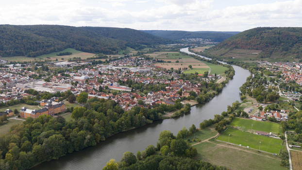Aerial view of the town of Kleinheubach along the Main river with Schloss Lowenstein surrounding forests and rolling hills in Kleinheubach Bavaria Germany. Aerial view of the town of Kleinheubach along the Main river with Schloss Lowenstein surrounding forests and rolling hills in Kleinheubach Bavaria Germany.