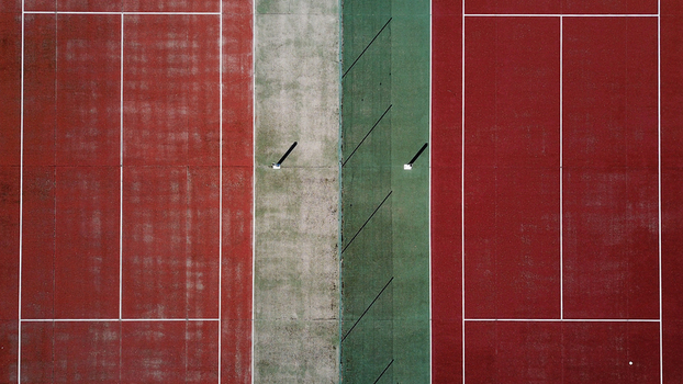 Aerial view of tennis courts with red and green surfaces in Jougne Bourgogne Franche Comte France. Aerial view of tennis courts with red and green surfaces in Jougne Bourgogne Franche Comte France.