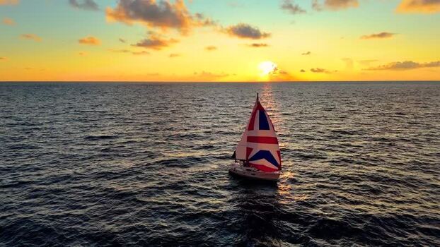 Aerial view of a sailboat at sunset in Kawaihae United States. Aerial view of a sailboat at sunset in Kawaihae United States.