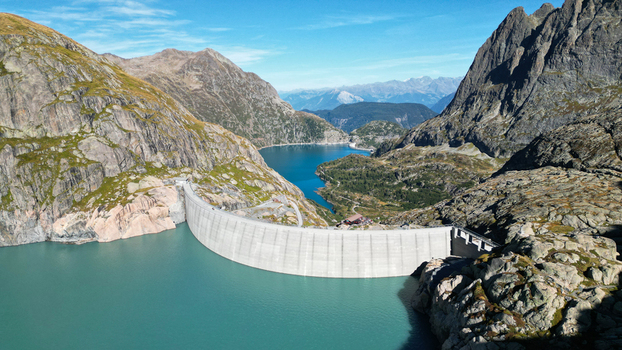 Aerial view of the Vieux Emosson Dam and its turquoise reservoir lake nestled among the rugged rocky peaks of the Swiss Alps in Finhaut Valais Switzerland. Aerial view of the Vieux Emosson Dam and its turquoise reservoir lake nestled among the rugged rocky peaks of the Swiss Alps in Finhaut Valais Switzerland.