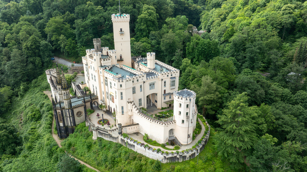 Aerial view of Stolzenfels Castle featuring its white towers and gothic architecture surrounded by a dense green forest Koblenz Rheinland Pfalz Germany. Aerial view of Stolzenfels Castle featuring its white towers and gothic architecture surrounded by a dense green forest Koblenz Rheinland Pfalz Germany.