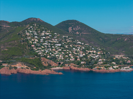 Aerial view of Le Trayas with hillside houses red rock cliffs and the Mediterranean Sea in Saint Raphael Provence Alpes Cote d Azur France. Aerial view of Le Trayas with hillside houses red rock cliffs and the Mediterranean Sea in Saint Raphael Provence Alpes Cote d Azur France.
