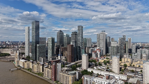 London United Kingdom 16 June 2026 Aerial view of Canary Wharf financial district skyline with modern skyscrapers the River Thames and residential apartment blocks.