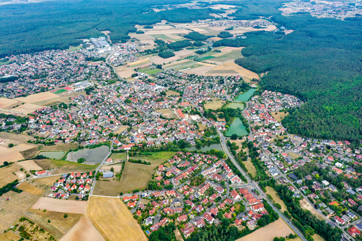 Aerial view of the town of Hemhofen with its red roofed houses surrounding green forests agricultural fields and small ponds Hemhofen Bavaria Germany. Aerial view of the town of Hemhofen with its red roofed houses surrounding green forests agricultural fields and small ponds Hemhofen Bavaria Germany.