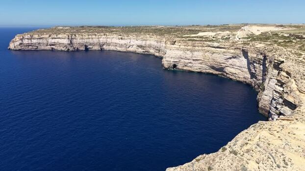 Aerial view of the rugged limestone cliffs at Dwejra Bay Malta. Aerial view of the rugged limestone cliffs at Dwejra Bay Malta.
