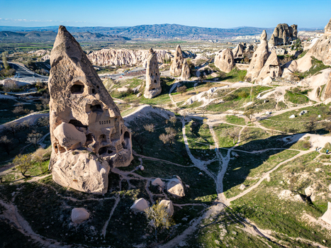 Aerial view of Uchisar Castle a prominent rock cut fortress surrounded by unique fairy chimneys and volcanic landscape in Cappadocia Uchisar Nevsehir Turkiye. Aerial view of Uchisar Castle a prominent rock cut fortress surrounded by unique fairy chimneys and volcanic landscape in Cappadocia Uchisar Nevsehir Turkiye.